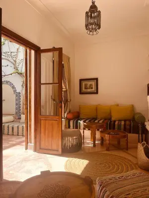 a living room with a couch and a door at Momo House- Riad Momo in Marrakech