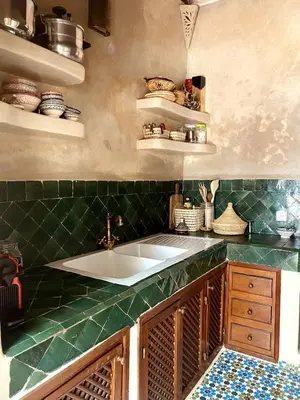 a kitchen with a sink and a green counter top at Momo House- Riad Momo in Marrakech