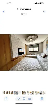 a bedroom with a bed and a tv in it at Duplex haut standing in Marrakech