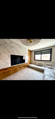 a living room with a couch and a ceiling fan at Duplex haut standing in Marrakech