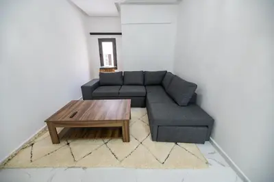 a living room with a couch and a coffee table at Jawhar Appart A4 in Marrakech