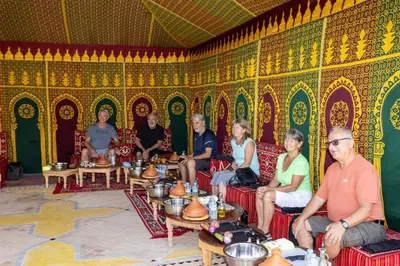 a group of people sitting at tables in a room at Maison safou in Marrakech