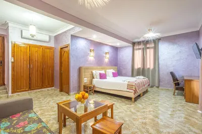 a hotel room with a bed and a table at Maison safou in Marrakech