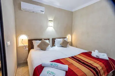 a bedroom with a bed with towels on it at Maison safou in Marrakech