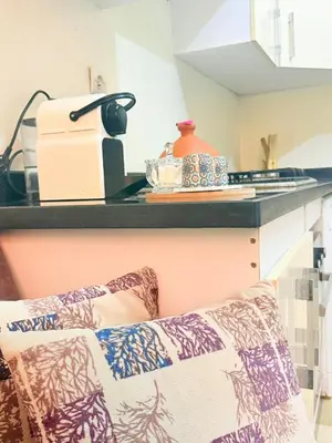 a kitchen with a counter top and a couch at Modern studio near the center in Marrakech