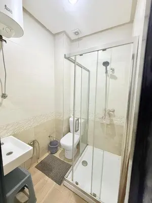 a bathroom with a shower and a toilet at Modern studio near the center in Marrakech