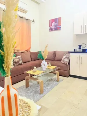 a living room with a couch and a coffee table at Modern studio near the center in Marrakech