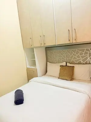 a small bedroom with two beds and cabinets at Modern studio near the center in Marrakech