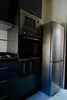 a kitchen with a stainless steel refrigerator and a microwave at good Appartement Marrakech in Marrakech
