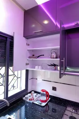 a kitchen with purple lighting and a counter top at good Appartement Marrakech in Marrakech