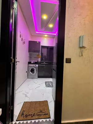 a kitchen with a purple light on the ceiling at good Appartement Marrakech in Marrakech