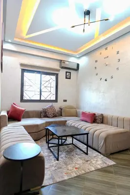 a living room with two couches and a table at good Appartement Marrakech in Marrakech