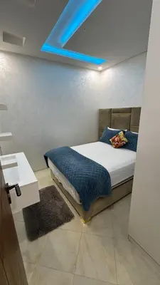 a bedroom with a bed with a blue ceiling at Le Joyau de la Ville in Marrakech