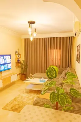 a living room with a bed and a tv at Appartement Cosy Majorelle au Centre-Ville - Netflix-Fibre in Marrakech
