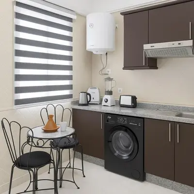 a kitchen with a washing machine and a table and chairs at Appartement Cosy Majorelle au Centre-Ville - Netflix-Fibre in Marrakech