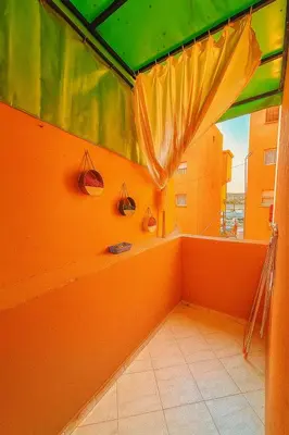 a room with an orange room with a window at Your favorite stay - 5min to M avenue & Gueliz in Marrakech