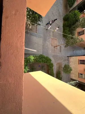 two people on a rope in front of a building at Your favorite stay - 5min to M avenue & Gueliz in Marrakech
