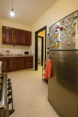 a kitchen with a refrigerator with magnets on it at Your favorite stay - 5min to M avenue & Gueliz in Marrakech