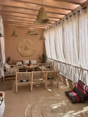 a living room with white curtains and a couch at Appartement avec terrasse XXL in Marrakech