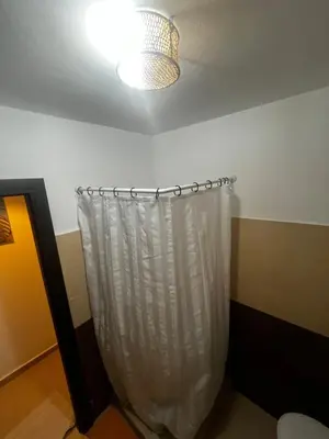 a room with a white shower curtain and a light at Appartement avec terrasse XXL in Marrakech