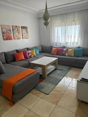 a living room with a couch and a table at GHIZLAN Apartment in Marrakech
