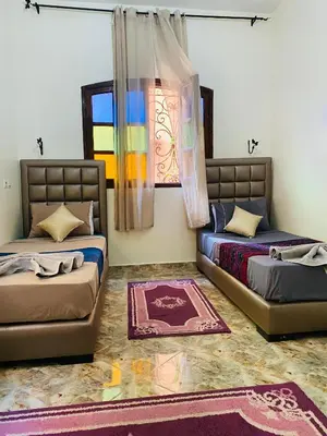 a room with two beds and a window at Dar béa in Marrakech