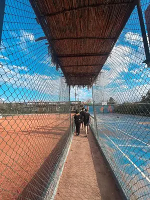 a group of people walking through a fence at MSC Hostel in Marrakech