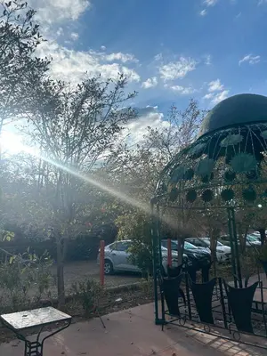 a sprinkler is spraying water into a gazebo at MSC Hostel in Marrakech