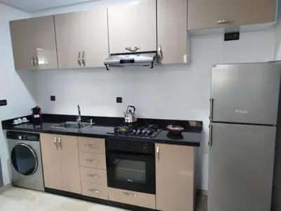 a kitchen with a stainless steel refrigerator and a dishwasher at Fabuleux appartement au centre ville de Marrakech à Gueliz Gare CTM et Train in Marrakech