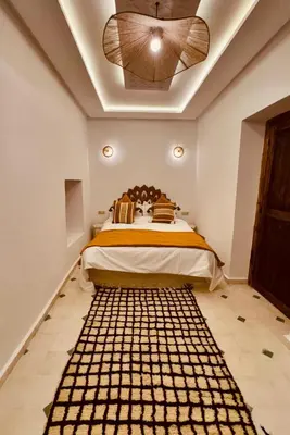 a bedroom with a bed and a ceiling fan at Riad Kimee Room 2 in Marrakech