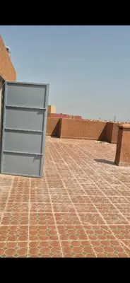 a metal door on top of a brick floor at Havre de paix en plein Marrakech in Marrakech