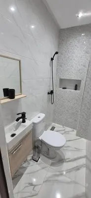 a white bathroom with a toilet and a sink at Havre de paix en plein Marrakech in Marrakech