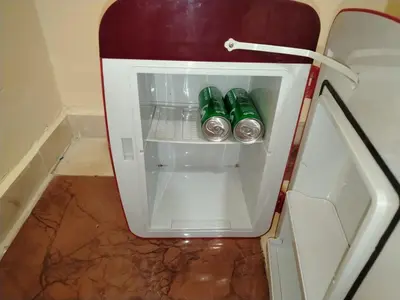a small refrigerator with two soda cans in it at غرفه هادئه في موقع رائع وقريبه من كولشي in Marrakech