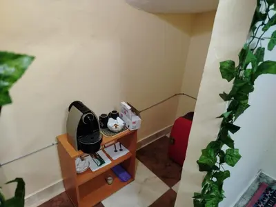a small room with a table and a red suitcase at غرفه هادئه في موقع رائع وقريبه من كولشي in Marrakech