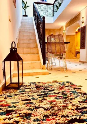 a hallway with a staircase with a rug on the floor at Riad Kimee Room 3 in Marrakech