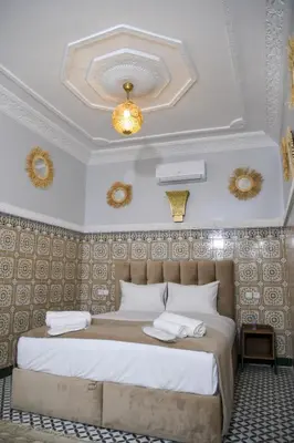 a bedroom with a large bed in a room at Riad Authentique en Exclusivité in Marrakech