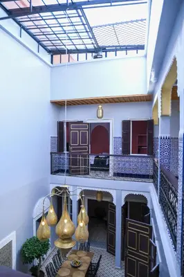 a living room with a table and some lights at Riad Authentique en Exclusivité in Marrakech