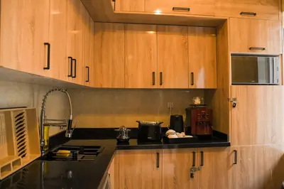 a kitchen with wooden cabinets and a counter top at Riad Authentique en Exclusivité in Marrakech
