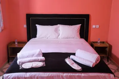 a bedroom with a bed with two towels on it at Riad Authentique en Exclusivité in Marrakech