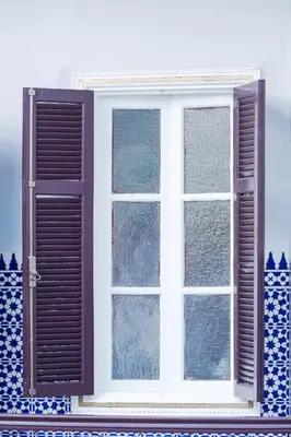 an open window on a house with blue and white at Riad Authentique en Exclusivité in Marrakech