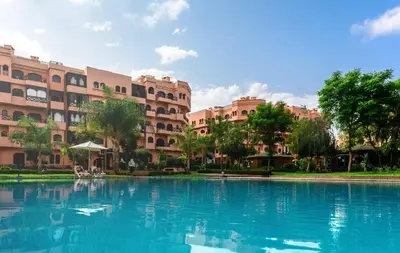 a large swimming pool in front of a building at Appartement PREMIUM VILLAGE in Marrakech