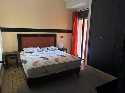 a bedroom with a bed and a window at Appartement PREMIUM VILLAGE in Marrakech