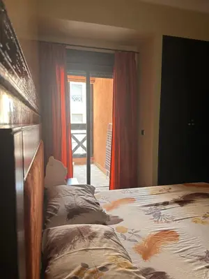 a bedroom with a bed and a door to a patio at Appartement PREMIUM VILLAGE in Marrakech