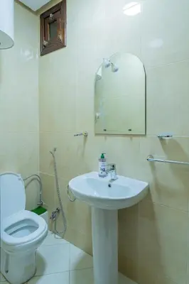 a bathroom with a toilet and a sink and a mirror at Charment et spacieux 2 chambres avec salon in Marrakech