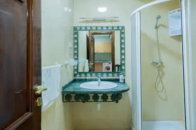 a bathroom with a sink and a mirror at Charment et spacieux 2 chambres avec salon in Marrakech