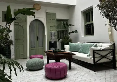 a living room with a couch and a table at Riad Akhdar Kasbah Breakfast included in Marrakech
