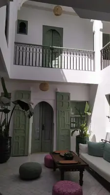 a living room with a couch and a table at Riad Akhdar Kasbah Breakfast included in Marrakech
