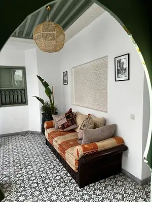 a living room with a couch in the corner at Riad Akhdar Kasbah Breakfast included in Marrakech