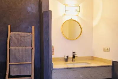 a bathroom with a sink and a mirror at Riad Akhdar Kasbah Breakfast included in Marrakech