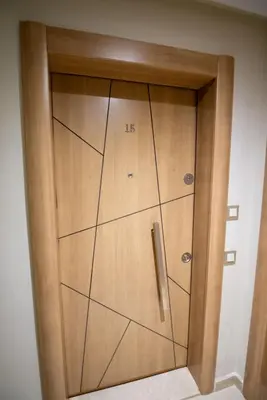 a wooden door with the number on it at Stylish Apartment Heart of Gueliz Netflix in Marrakech
